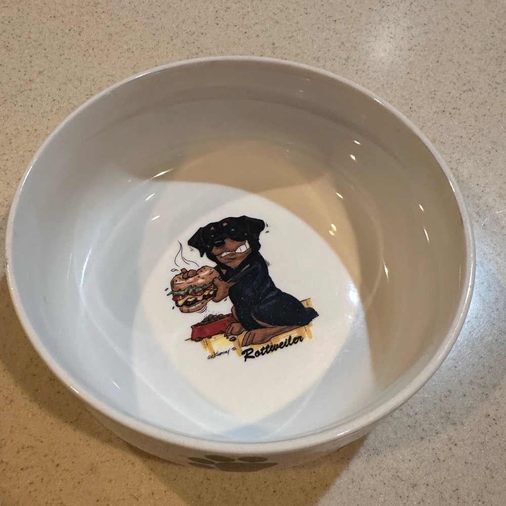 Rosalinde white dog bowl with Rottweiler and paw prints decor.  Good shape.